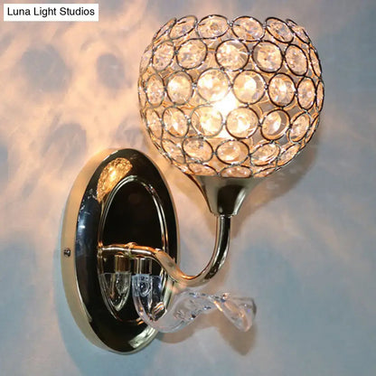 Modern chrome and light blue crystal globe sconce with polished chrome base and faceted crystals for bedroom wall light