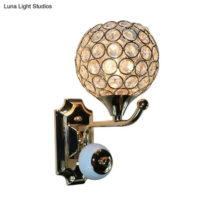 Modern chrome and light blue crystal globe sconce with faceted crystals in polished brass for bedroom wall lighting