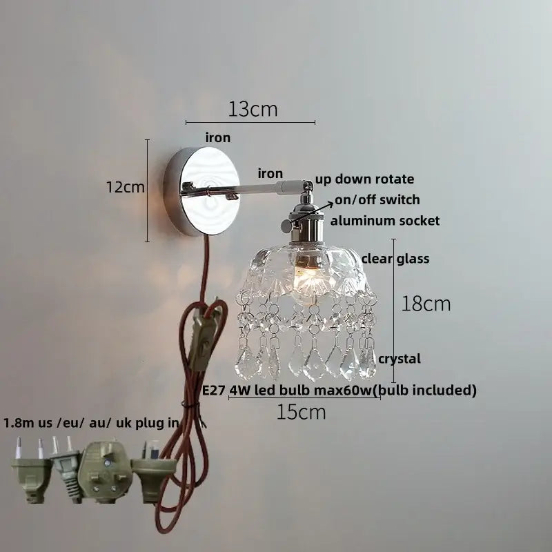 Modern chrome wall light fixture with polished iron arm, clear glass shade, and crystal teardrop accents for bedroom lamp