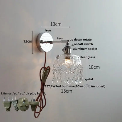 Modern chrome wall light fixture with polished iron arm, clear glass shade, and crystal teardrop accents for bedroom lamp