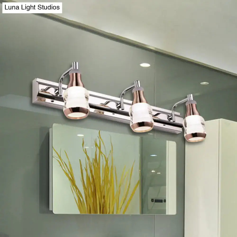 Modern chrome and rose gold vanity wall light with three glass shades product includes a stylish bathroom fixture
