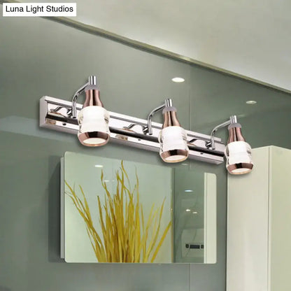 Modern chrome and rose gold vanity wall light with three glass shades product includes a stylish bathroom fixture