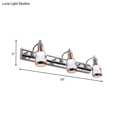 Modern chrome and rose gold vanity wall light with three frosted glass shades and sleek chrome finish for bathroom use