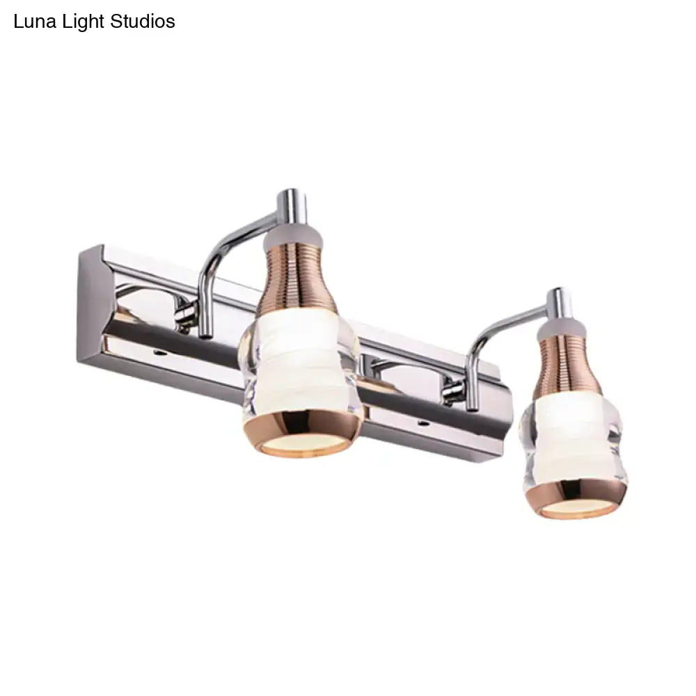 Modern chrome and rose gold vanity wall light with two warm-toned glass shades included in product includes