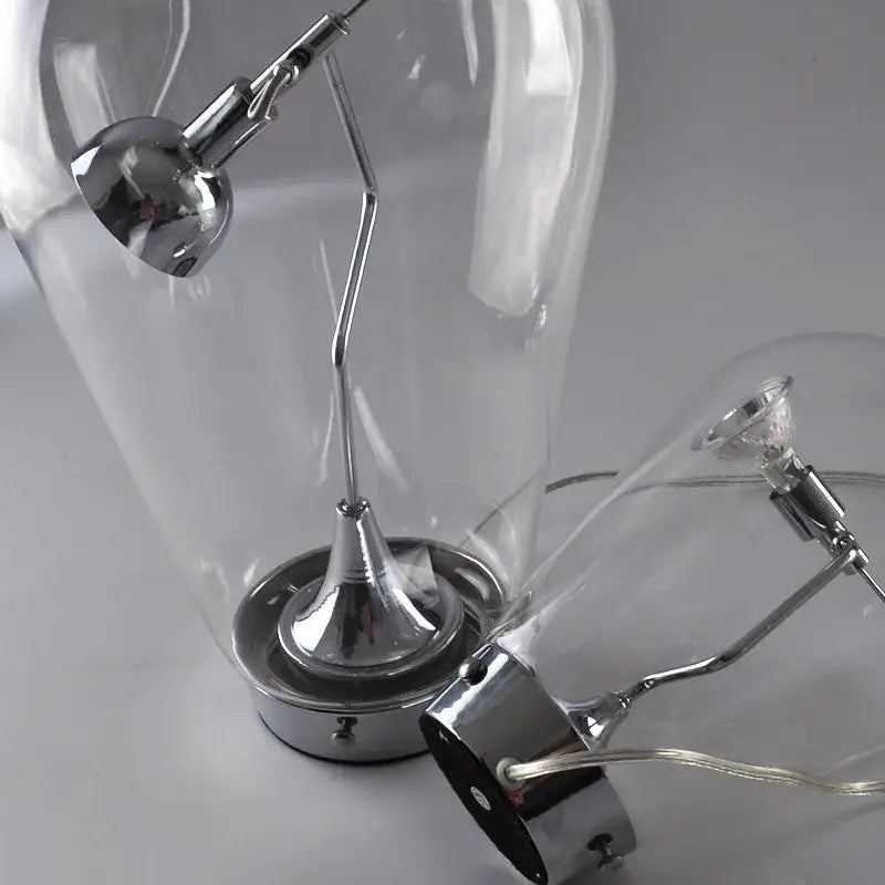 Modern chrome and transparent blow glass table lamp with articulated arm by decorbites lodes blow for living room decor