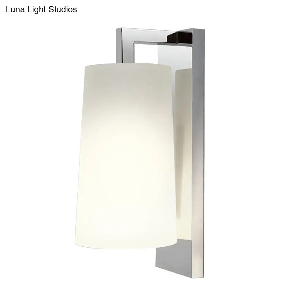 Modern chrome wall lamp with frosted white glass cylindrical shade light type and compact fixture height for bedroom use