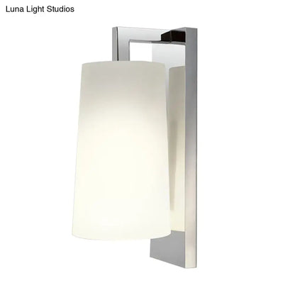 Modern chrome wall lamp with frosted white glass cylindrical shade light type and compact fixture height for bedroom use