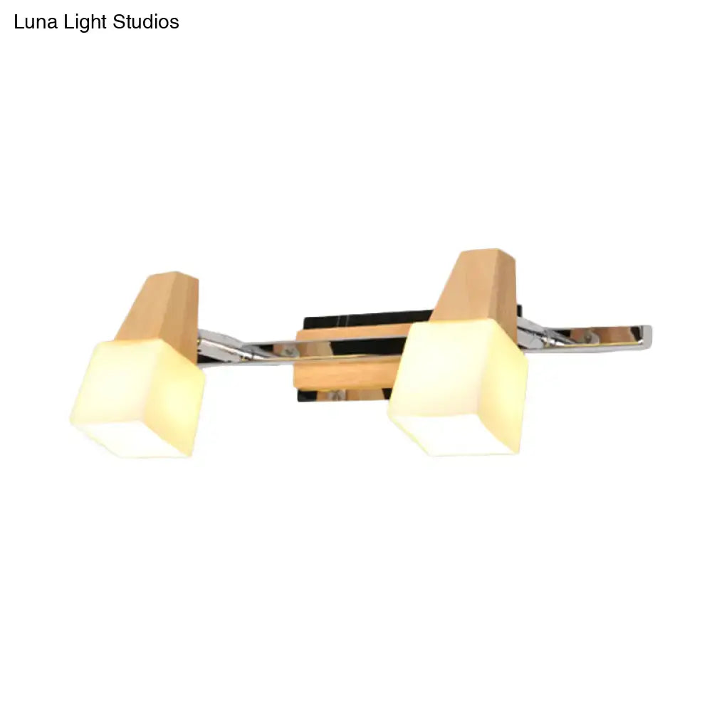 Modern chrome and wood cube vanity light fixture with beige cube vanity shades for bathroom lighting use
