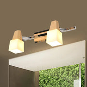 Modern chrome and wood cube vanity light fixture with sleek arms and warm beige cube vanity lampshades for bathroom