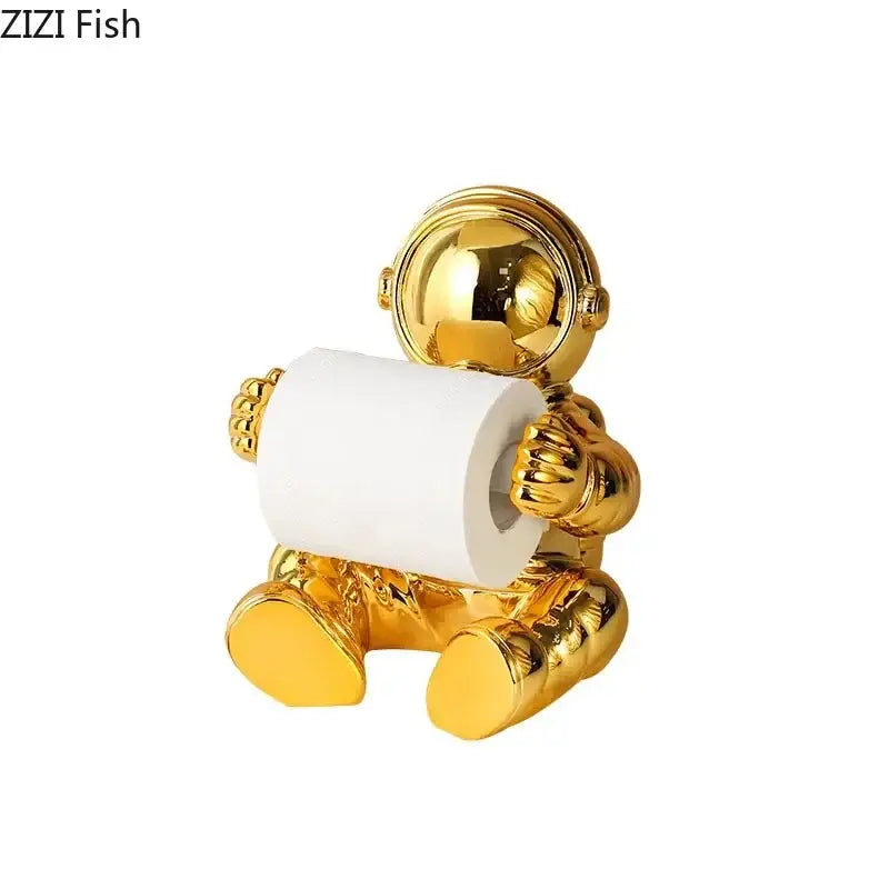 Golden astronaut tissue box holder with shiny metallic finish for modern chrome living room decor