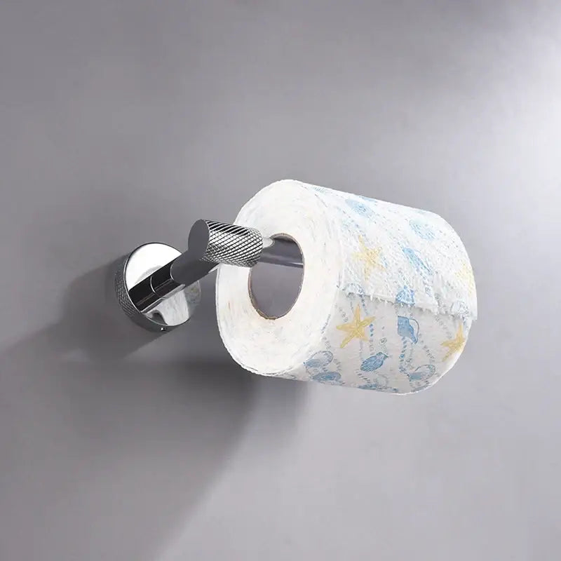 Modern chrome bathroom essentials set featuring a chrome toilet paper holder with textured grip holding starfish tissue from decorbites bathroom essentials