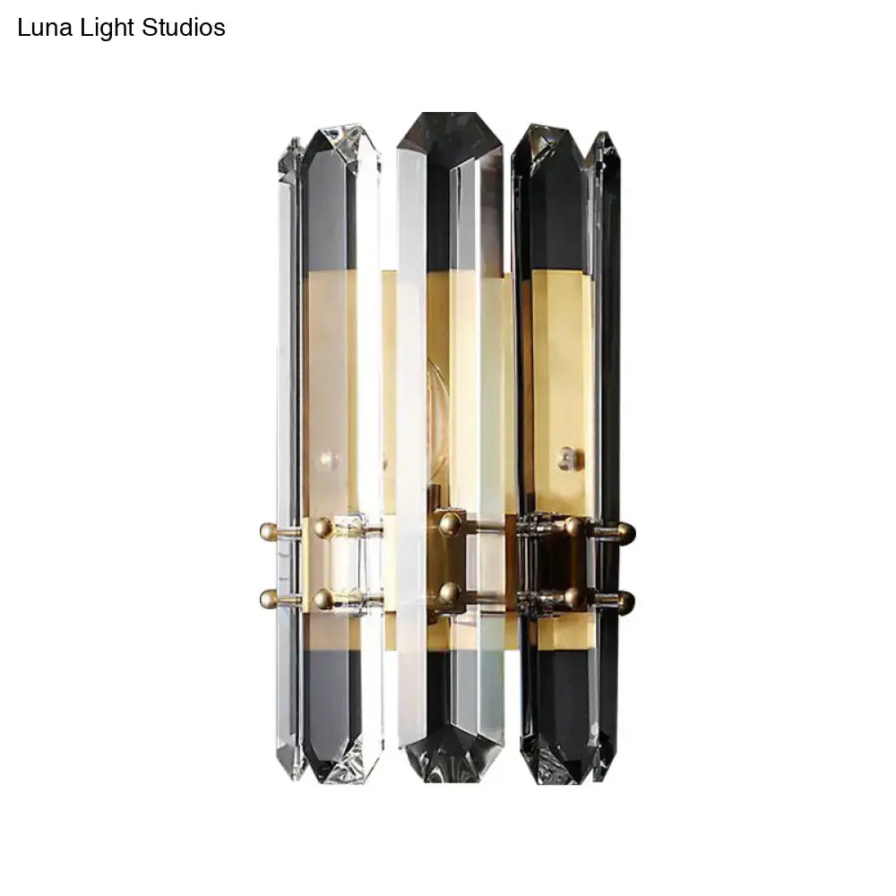 Elegant modern chrome and black crystal wall sconce with direct wired electric power source and brass accents for bedroom use