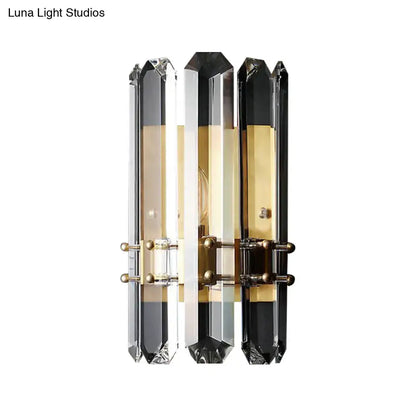 Elegant modern chrome and black crystal wall sconce with direct wired electric power source and brass accents for bedroom use