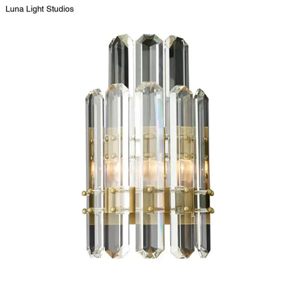 Modern chrome and black crystal wall sconce with faceted rods and brass accents designed for direct wired electric power source
