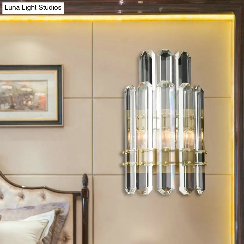 Elegant crystal wall sconce with faceted glass rods and gold metal accents featuring a direct wired electric power source