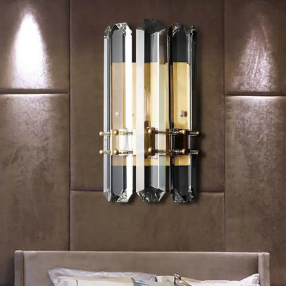 Modern chrome and black crystal wall sconce with three vertical panels and direct wired electric power source