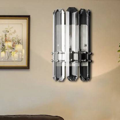 Modern chrome and black crystal wall sconce with three faceted glass bars featuring polished chrome direct wired power source