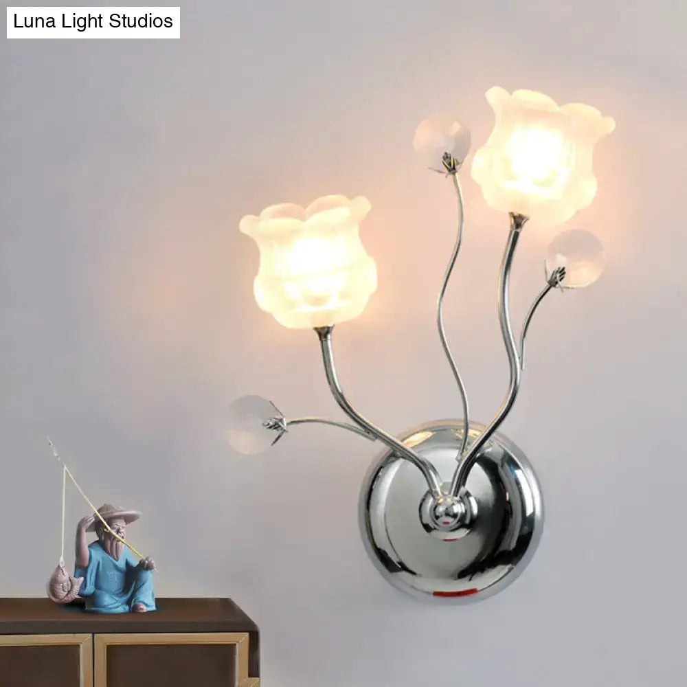 Modern chrome bloom shade wall sconce with clear crystal frosted glass flowers and scrolling arm for bedroom lighting
