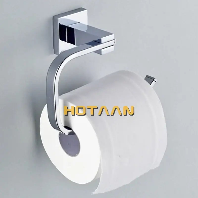 Modern chrome finished toilet paper holder with angular design holding white roll in stainless steel bathroom accessories set
