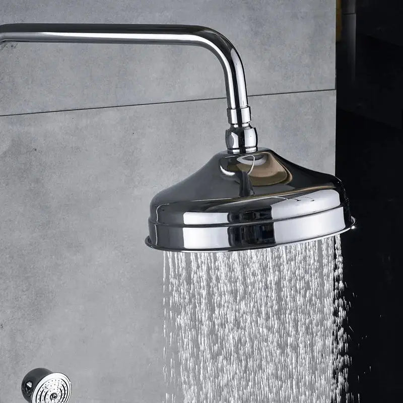 Modern chrome brass shower mixer with dual handle and round rainfall showerhead with visible water spray