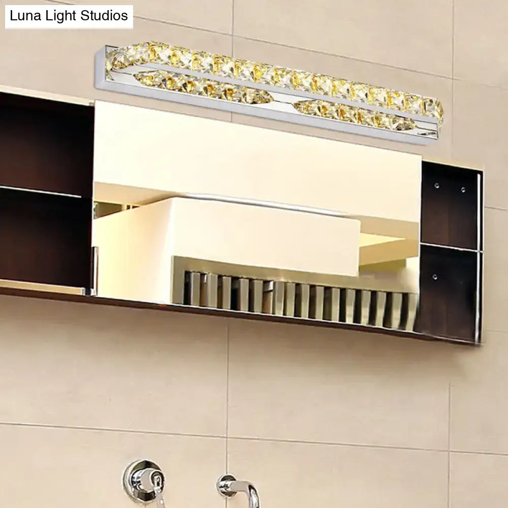A modern chrome clear amber crystal led vanity light with golden crystal accents for bathroom sconce lighting