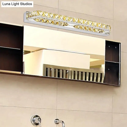 A modern chrome clear amber crystal led vanity light with golden crystal accents for bathroom sconce lighting