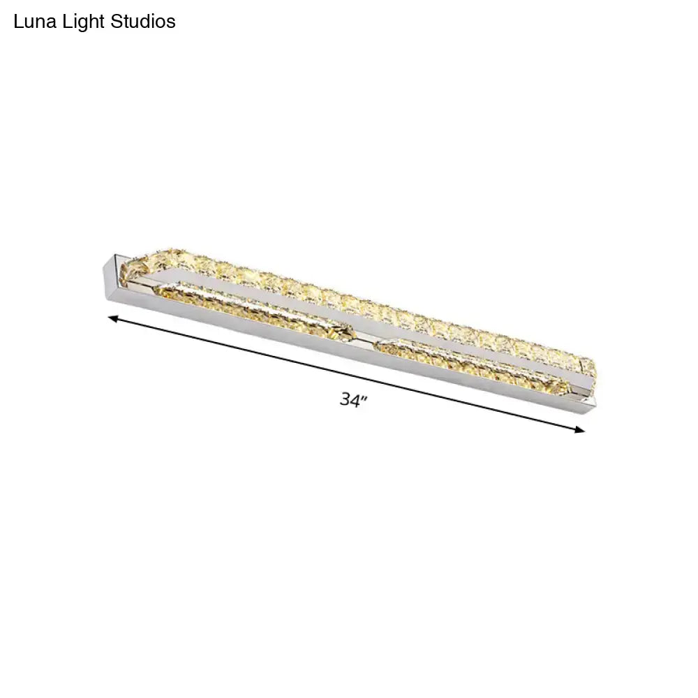 A sleek 34-inch modern chrome bathroom vanity light with clear amber crystal accents and polished chrome frame