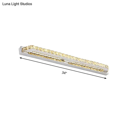 A sleek 34-inch modern chrome bathroom vanity light with clear amber crystal accents and polished chrome frame