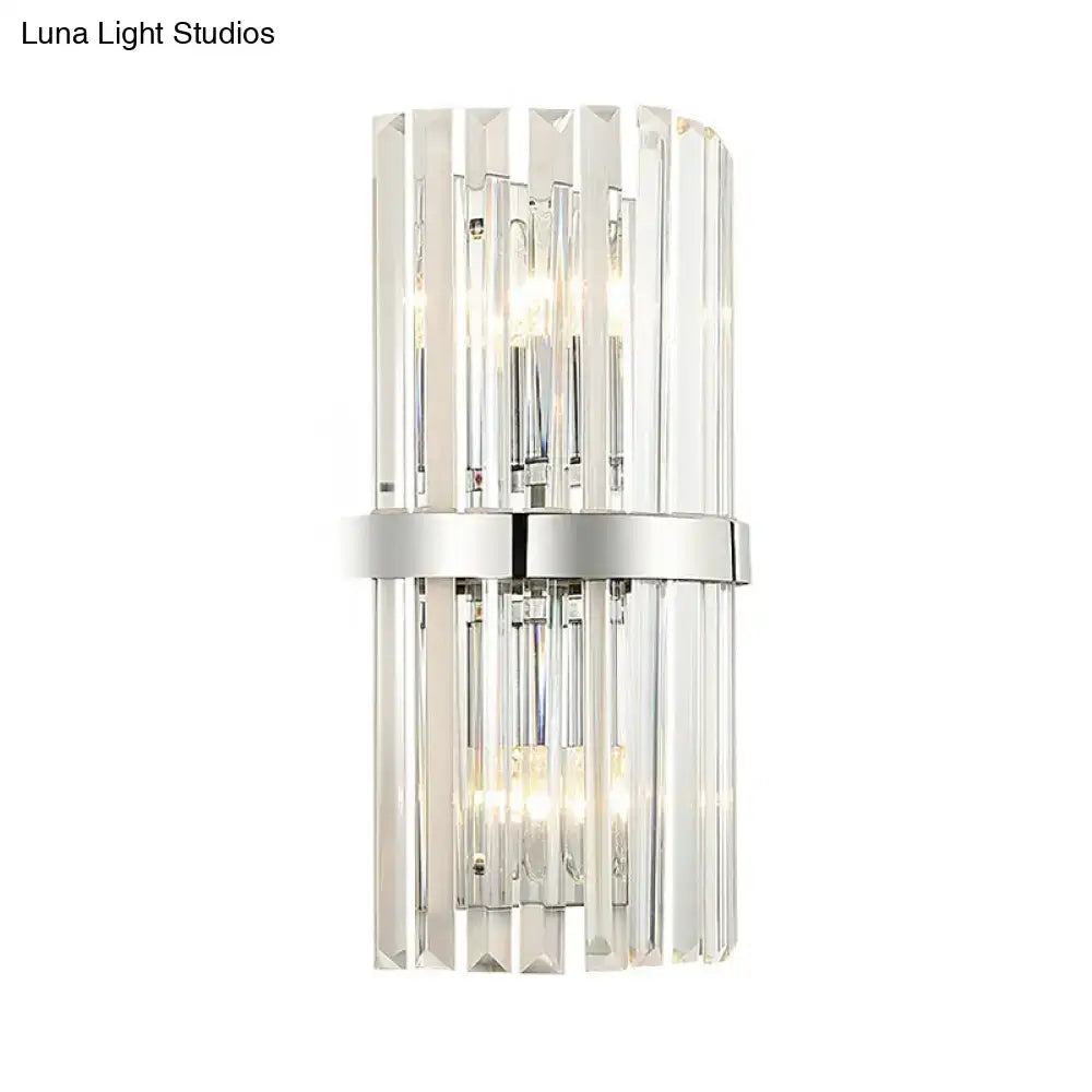 Modern chrome clear crystal cylinder wall sconce featuring vertical faceted glass rods and polished chrome band for bedroom lighting