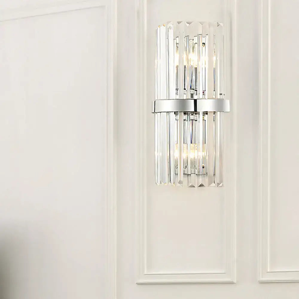 Modern chrome clear crystal cylinder wall sconce with vertical crystal rods and sleek chrome band for bedroom lighting
