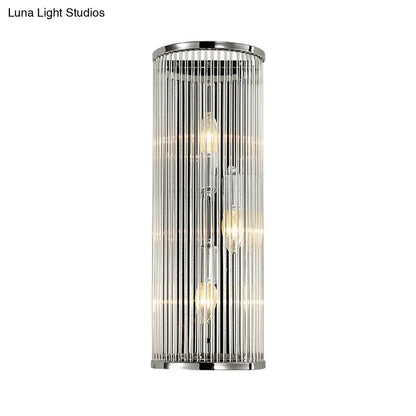 Modern chrome cylindrical wall light with clear crystal shade featuring vertical glass rods and three exposed filament bulbs