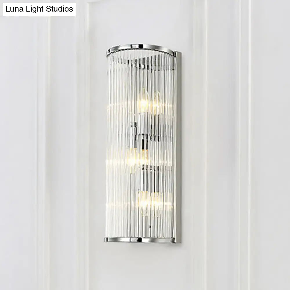 Modern chrome clear crystal shade wall light with vertical rods and three illuminated bulbs for bedroom use