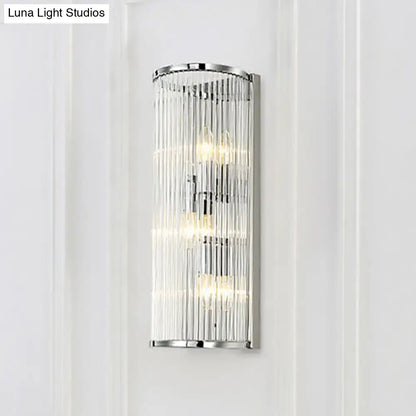 Modern chrome clear crystal shade wall light with vertical rods and three illuminated bulbs for bedroom use
