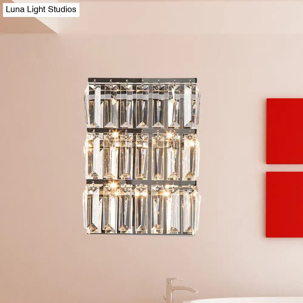 Modern chrome clear crystal wall lamp with three horizontal rows of faceted crystal prisms for bedroom use