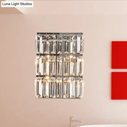 Modern chrome clear crystal wall lamp with three horizontal rows of faceted crystal prisms for bedroom use