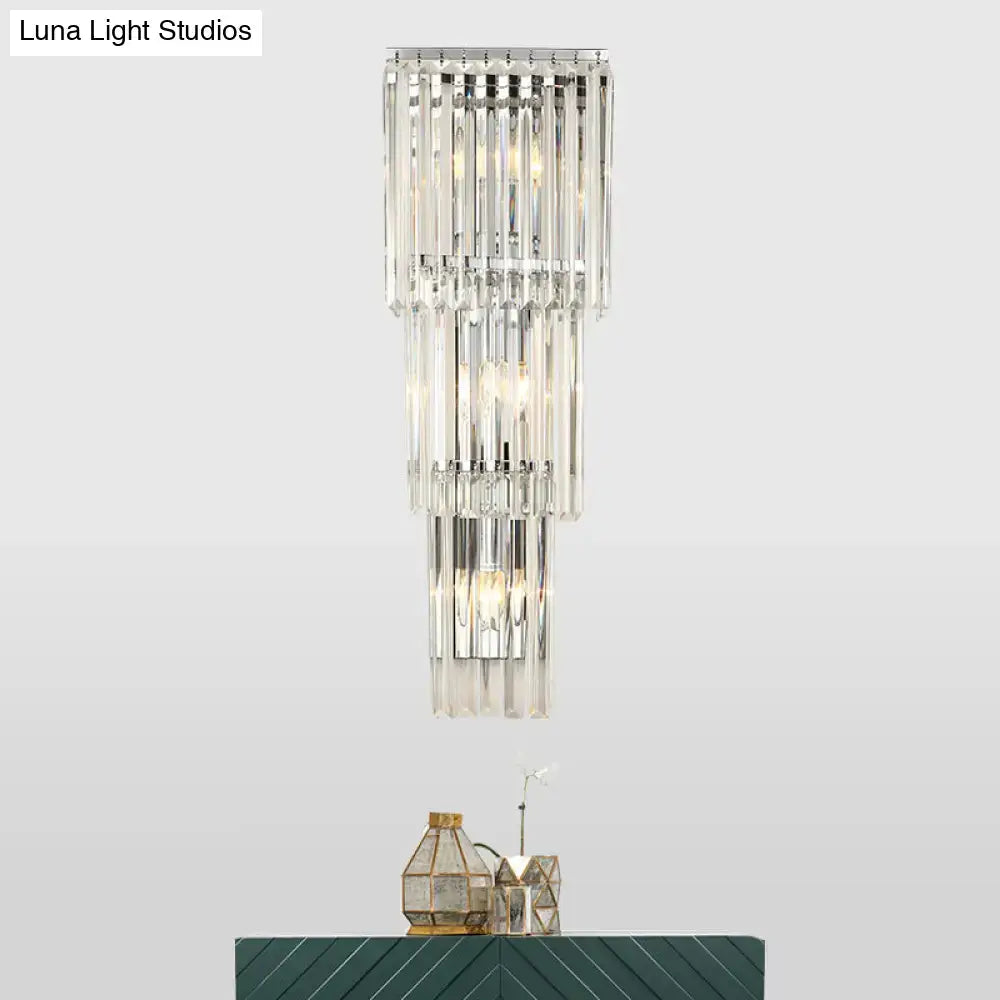 Modern chrome clear glass wall sconce light with tiered crystal clear glass shade and polished chrome frame for bedroom