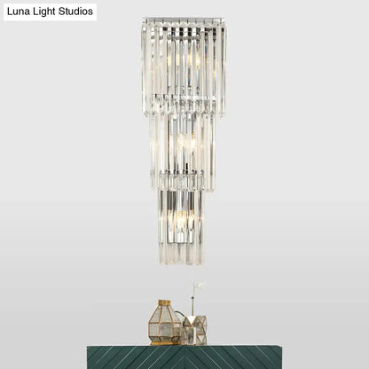 Modern chrome clear glass wall sconce light with tiered crystal clear glass shade and polished chrome frame for bedroom