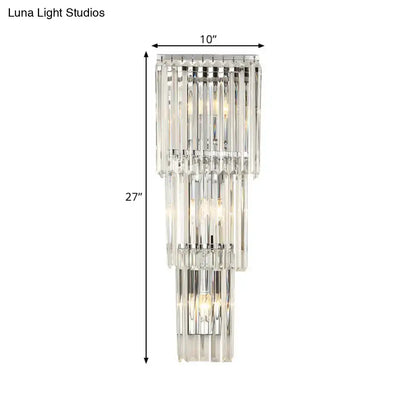 Modern chrome clear glass wall sconce light featuring a tiered crystal design with cascading clear glass shade rods