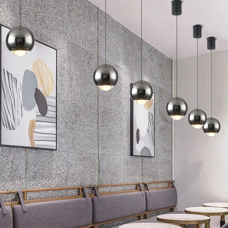 Modern chrome and copper ball pendant light with spherical chrome finish designed as a pendant light modern chandelier