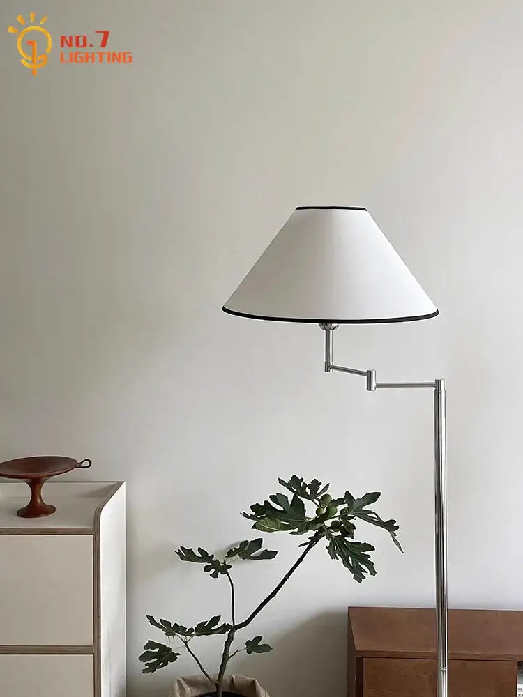 Modern chrome cream rocker arm floor lamp with white conical shade and black trim for living room lighting