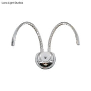 Modern chrome crystal arch wall sconce with two curved arms and warm white light for 110v-120v or 220v-240v use