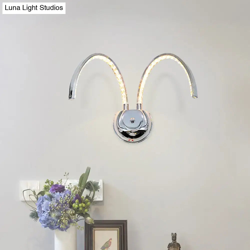 Modern chrome crystal arch wall sconce with two curved illuminated arms resembling ram horns warm white light 110v-120v