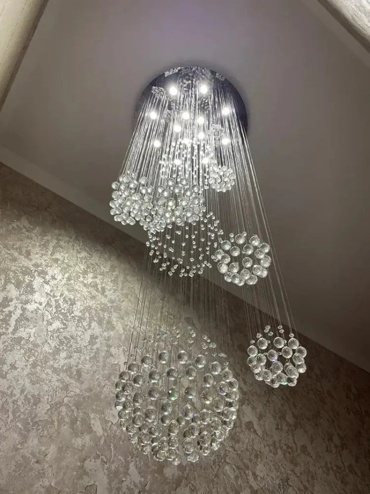 A modern chrome crystal ball design chandelier with cascading clear glass spheres for staircase lighting decorbites chandelier set