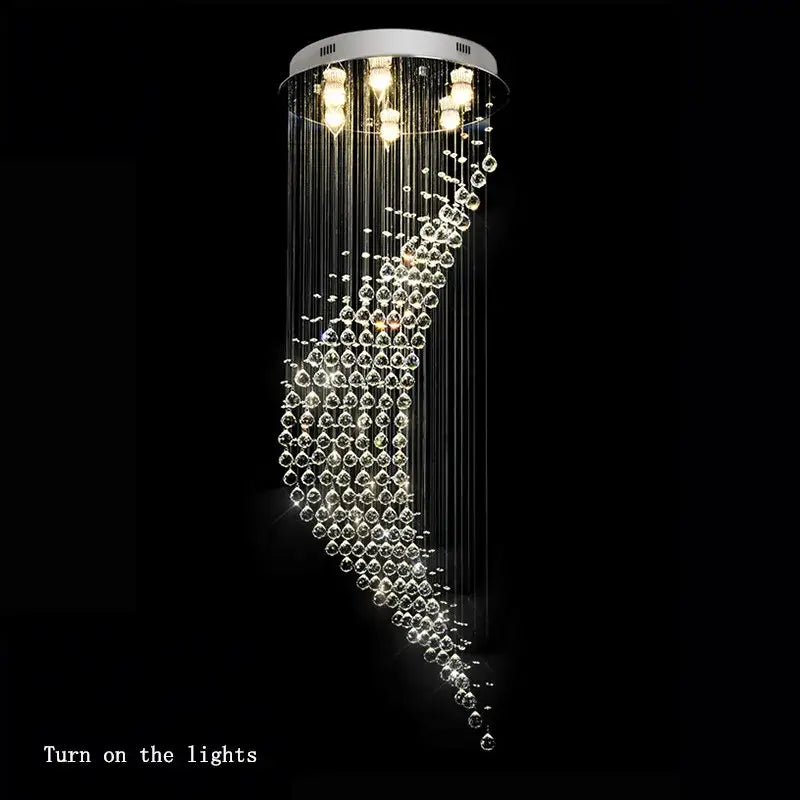 A modern chrome decorbites crystal ball spiral chandelier with clear glass beads and white circular ceiling mount