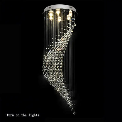 A modern chrome decorbites crystal ball spiral chandelier with clear glass beads and white circular ceiling mount