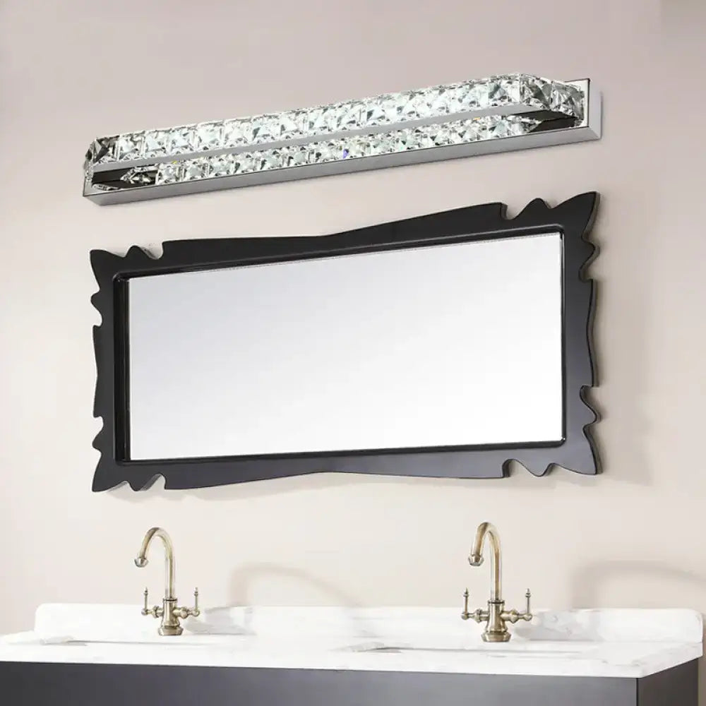 A sleek modern chrome crystal encrusted wall light fixture with embedded clear crystals and compact fixture height