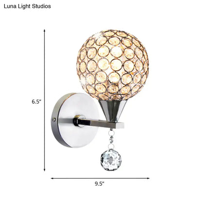 Modern chrome crystal encrusted wall light with crystalline globe and hanging crystal droplet for bedroom sconce lighting