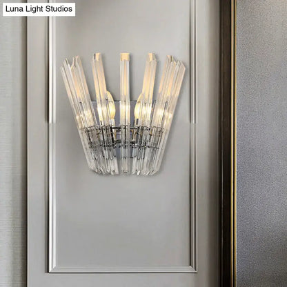 Modern chrome crystal fan wall mount light featuring clear faceted glass rods arranged radially around chrome mount light