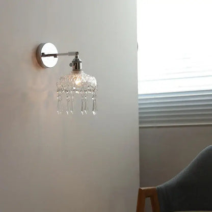 Modern chrome crystal led wall light with polished chrome finish and dangling clear glass beads for elegant bedroom decorbites crystal led sconce