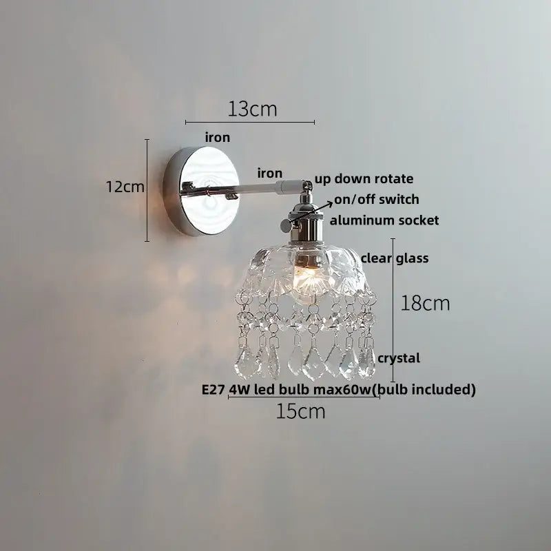 A sleek chrome wall light with clear glass shade and dangling crystal droplets from decorbites crystal led wall light